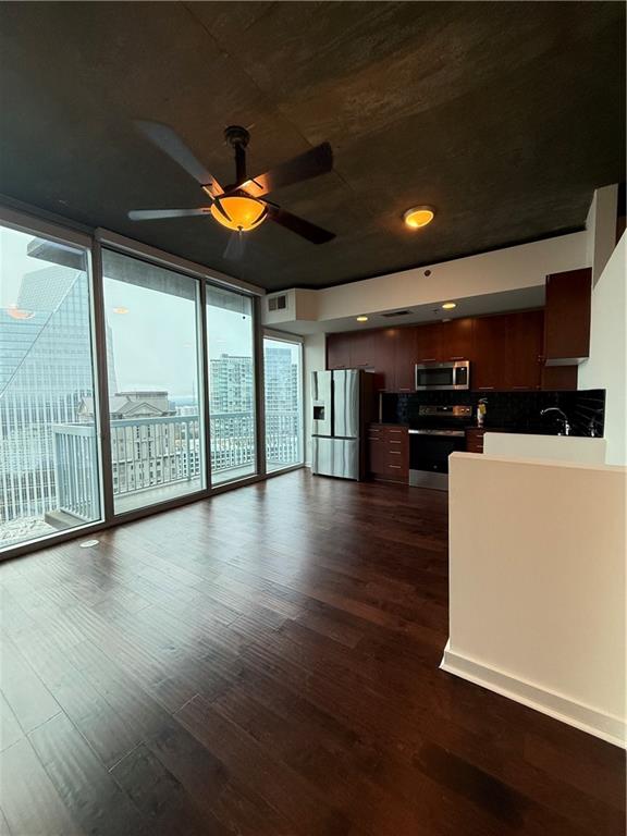 3324 Peachtree Road Northeast, Unit 2406 Atlanta, GA 30326 - Photo 4 of 12 an empty room with wooden floor and windows