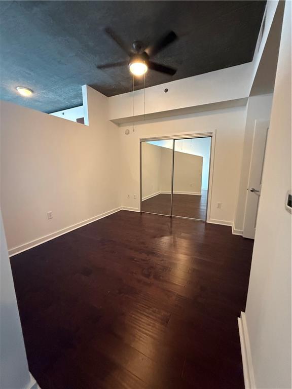 3324 Peachtree Road Northeast, Unit 2406 Atlanta, GA 30326 - Photo 6 of 12 an empty room with wooden floor and windows