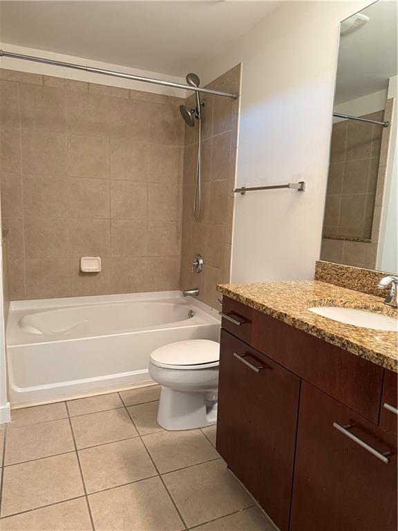 3324 Peachtree Road Northeast, Unit 2406 Atlanta, GA 30326 - Photo 8 of 12 a bathroom with a granite countertop bathtub shower sink vanity and toilet