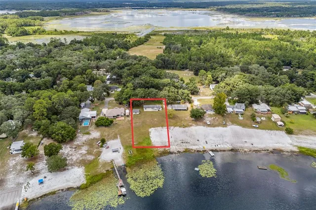 an aerial view of a house with a lake view