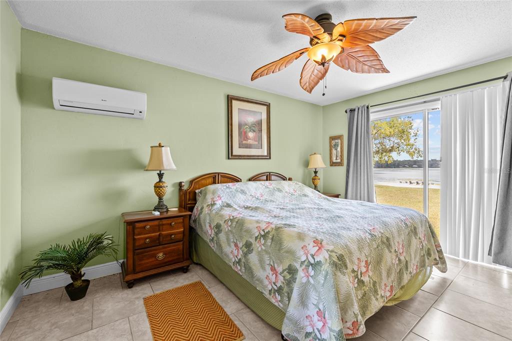 6417 Baker Road Keystone Heights, FL 32656 - Photo 11 of 32 a bedroom with a bed and a chandelier