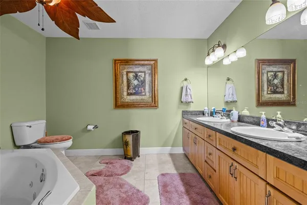 a bathroom with a tub sink and mirror