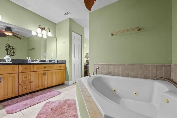 a bedroom with a bed and ceiling fan