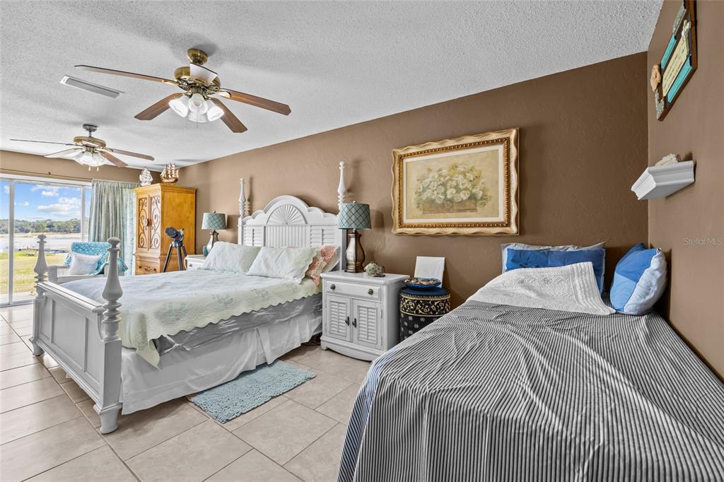 6417 Baker Road Keystone Heights, FL 32656 - Photo 15 of 32 a bedroom with a bed and ceiling fan