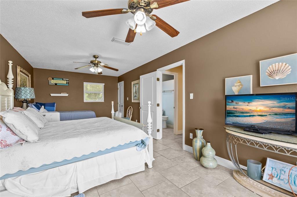 6417 Baker Road Keystone Heights, FL 32656 - Photo 16 of 32 a spacious bedroom with a bed and a flat screen tv