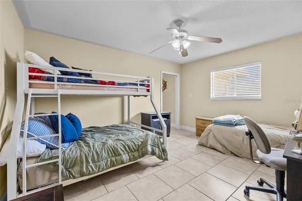 a bedroom with bed and a chandelier