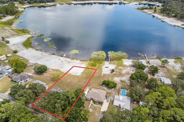 an aerial view of a house with outdoor space swimming pool and lake view