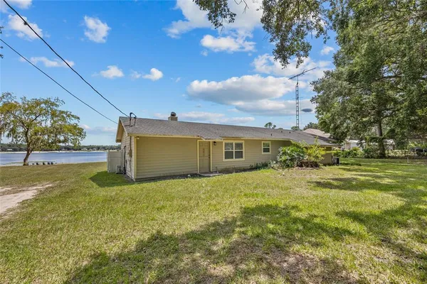 a view of a house with a backyard