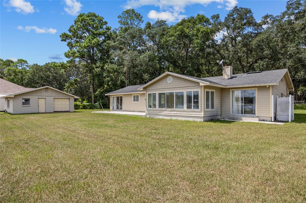 6417 Baker Road Keystone Heights, FL 32656 - Photo 25 of 32 a front view of a house with a garden