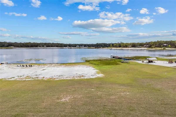 an aerial view of a house with a lake view