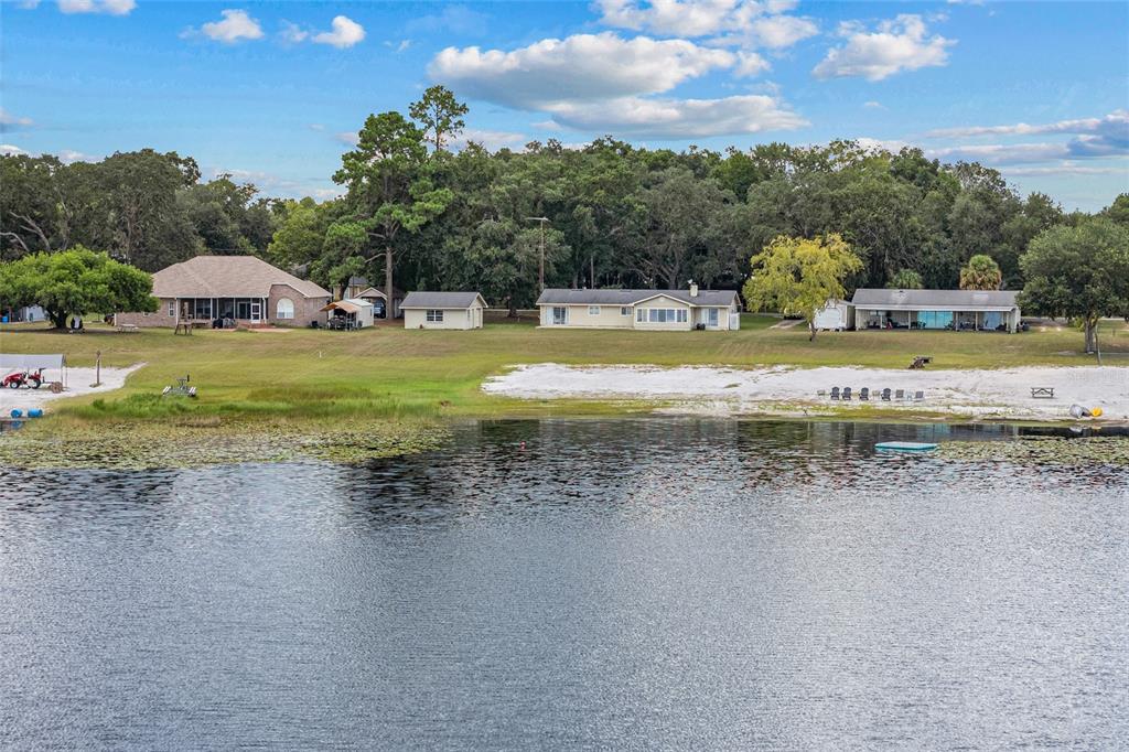 6417 Baker Road Keystone Heights, FL 32656 - Photo 30 of 32 a view of a swimming pool with a yard and a large tree