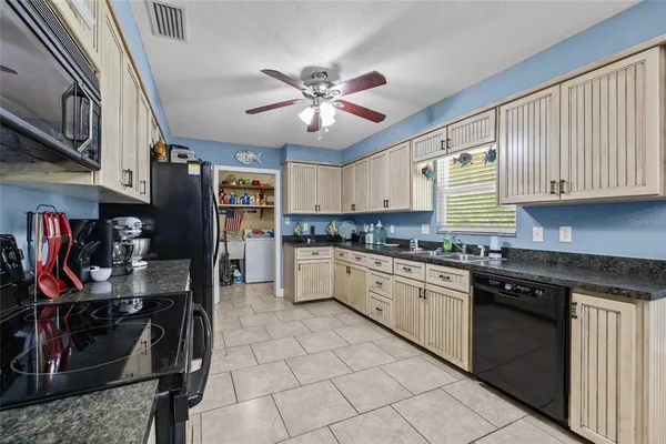 a kitchen with stainless steel appliances granite countertop a stove sink microwave and cabinets