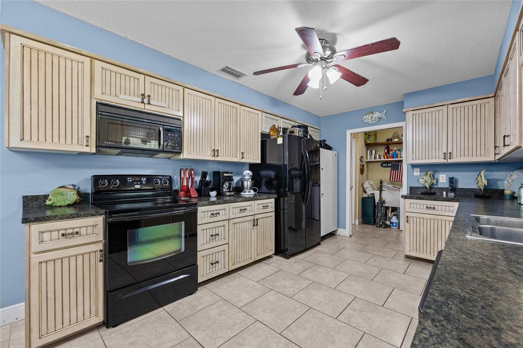 6417 Baker Road Keystone Heights, FL 32656 - Photo 7 of 32 a kitchen with stainless steel appliances granite countertop a stove sink microwave and cabinets