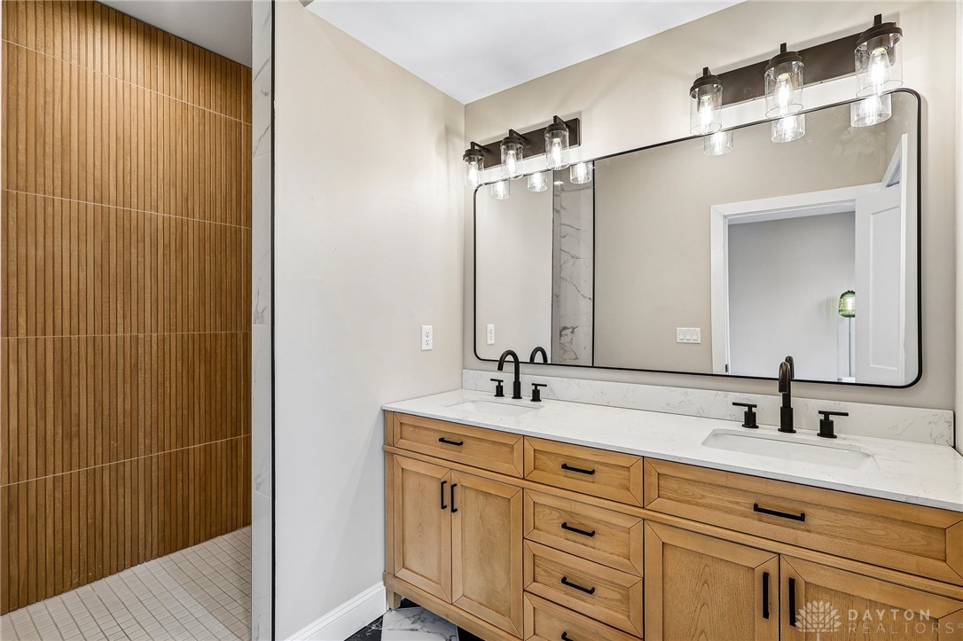3906 Edwards Road, Unit C Cincinnati, OH 45209 - Photo 3 of 46 This modern bathroom features a spacious vanity and a walk-in shower.