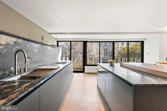a living room with furniture and a glass door