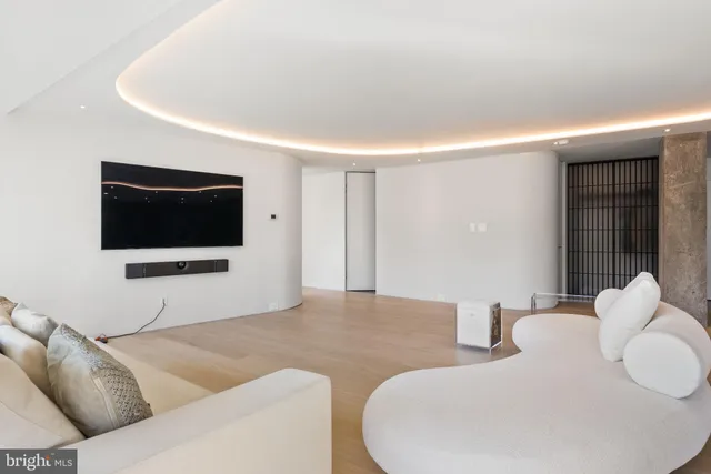 a large bed sitting in a bedroom and a lamp