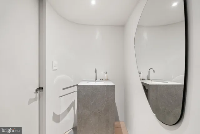 a bathroom with a sink a mirror and a shower