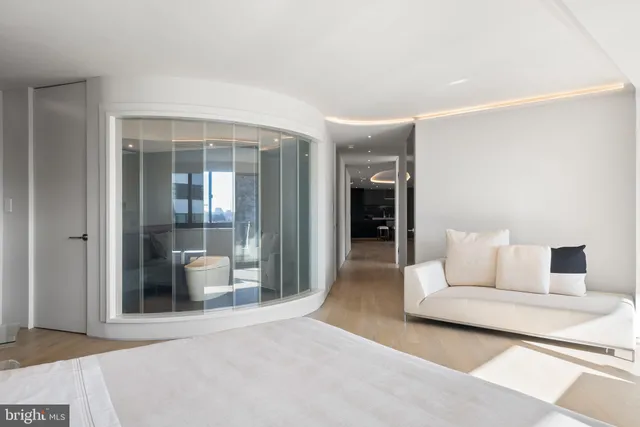 a living room with a bed furniture and a flat screen tv