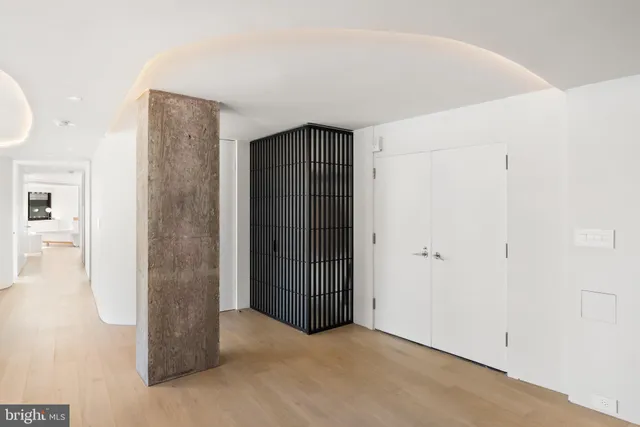 a living room with furniture and a large window with outer view