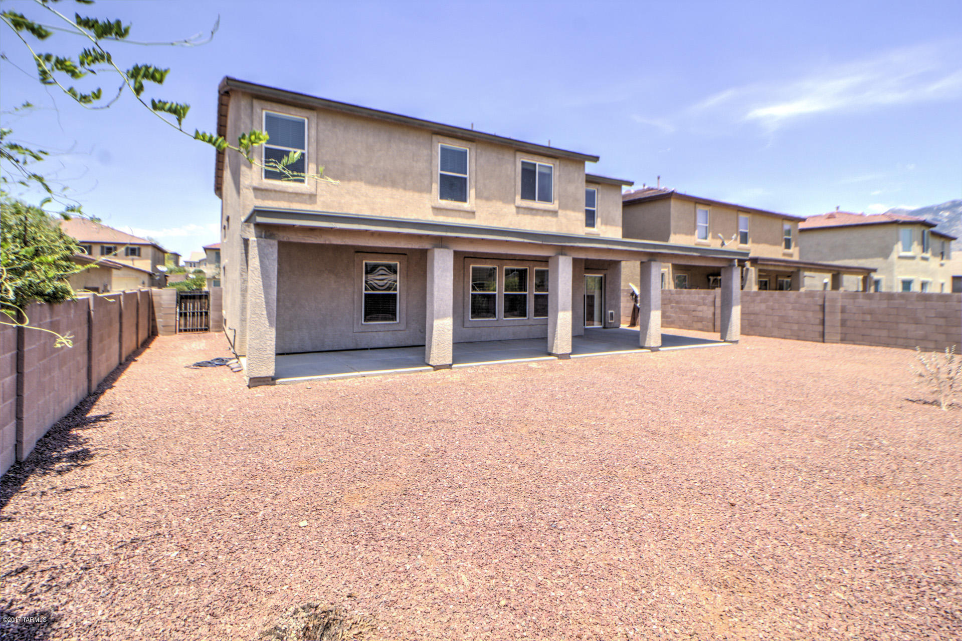 3588 East Mecate Road Tucson, AZ 85739 - Photo 32 of 36 a front view of a house with a yard