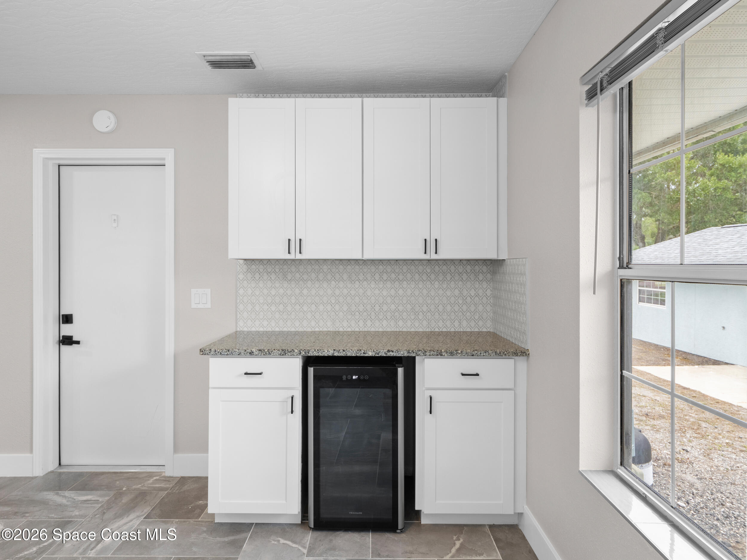 3480 Weber Road Malabar, FL 32950 - Photo 13 of 45 a kitchen with a sink and cabinets