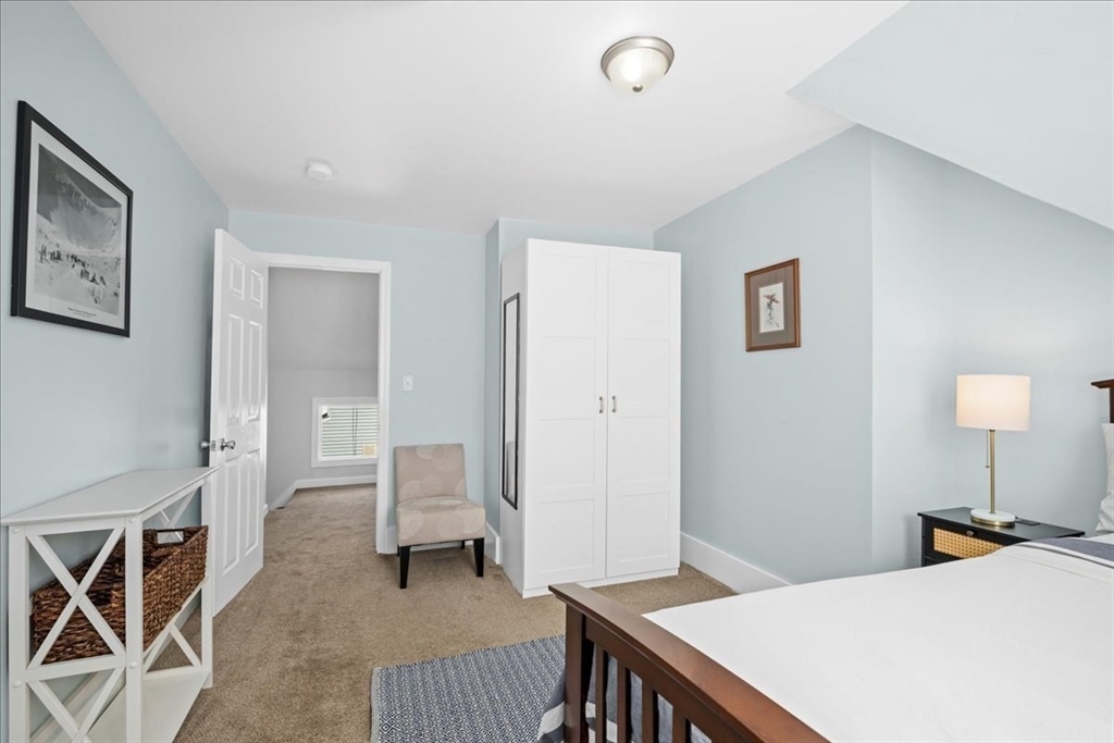 126 Beaconsfield Road Worcester, MA 01602 - Photo 22 of 42 a bedroom with a bed and a chandelier