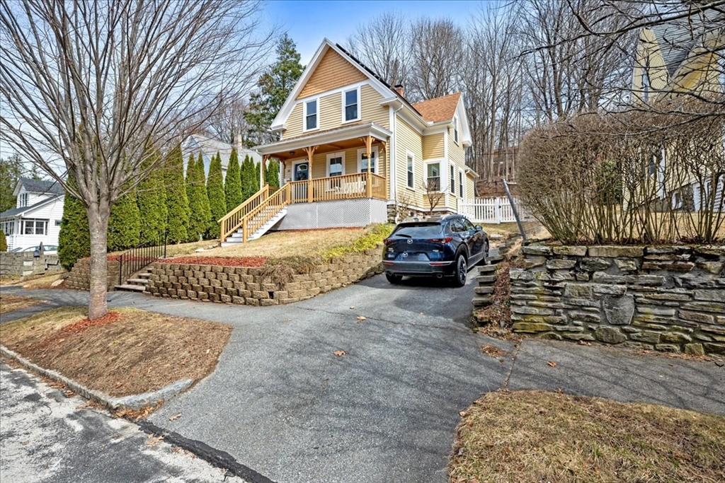 126 Beaconsfield Road Worcester, MA 01602 - Photo 41 of 42 a view of a white house with a yard covered in snow