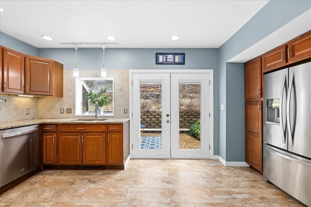 126 Beaconsfield Road Worcester, MA 01602 - Photo 6 of 42 a large kitchen with stainless steel appliances granite countertop a refrigerator and a sink
