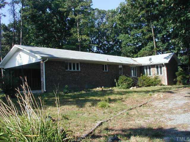 1671 McGhees Mill Road Roxboro, NC 27574 - Photo 1 of 1 a backyard of a house with yard and tree