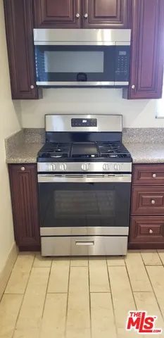 a stove top oven sitting inside of a kitchen