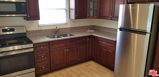 a kitchen with a refrigerator and a sink