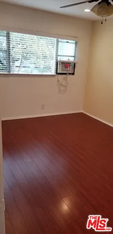 a view of a floor to ceiling window and wooden floor