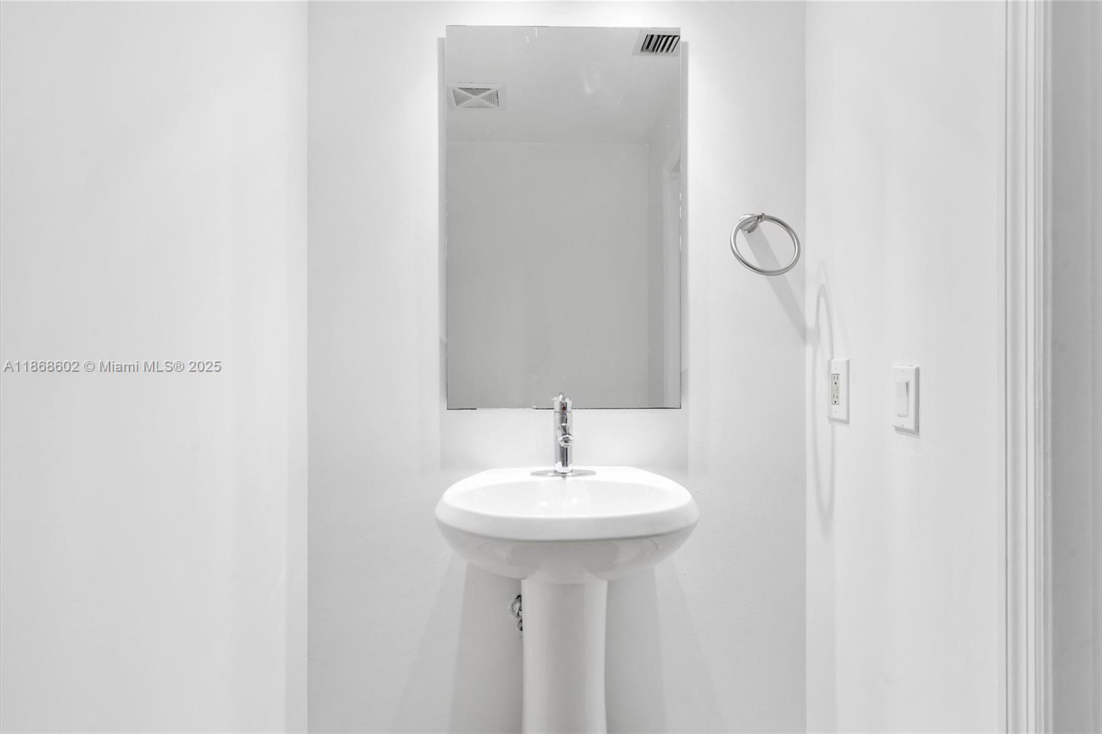 60 Southwest 13th Street, Unit 2420 Miami, FL 33130 - Photo 12 of 33 a bathroom with a sink and a mirror