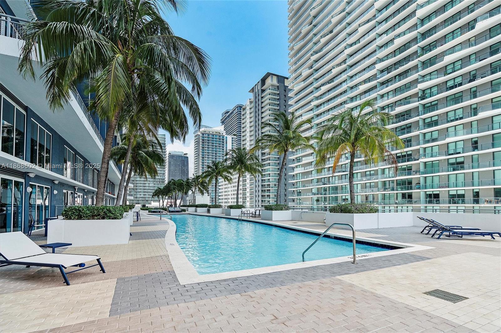 60 Southwest 13th Street, Unit 2420 Miami, FL 33130 - Photo 24 of 33 a view of a swimming pool with a patio