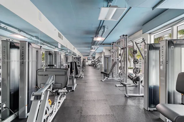 a living room with lots of furniture and a refrigerator