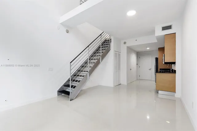 a kitchen with stainless steel appliances a stove microwave and sink