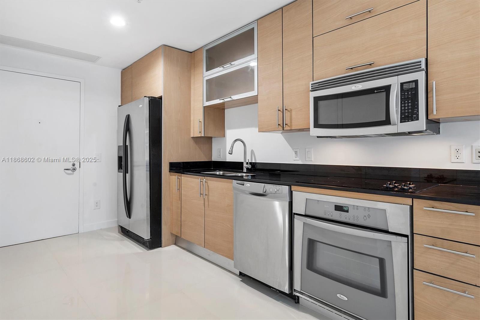 60 Southwest 13th Street, Unit 2420 Miami, FL 33130 - Photo 8 of 33 a kitchen with stainless steel appliances a stove microwave and sink