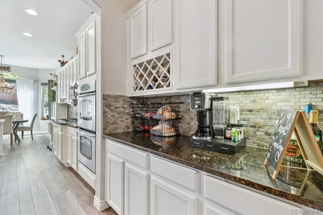 a kitchen with stainless steel appliances granite countertop a lot of counter space and wooden floor