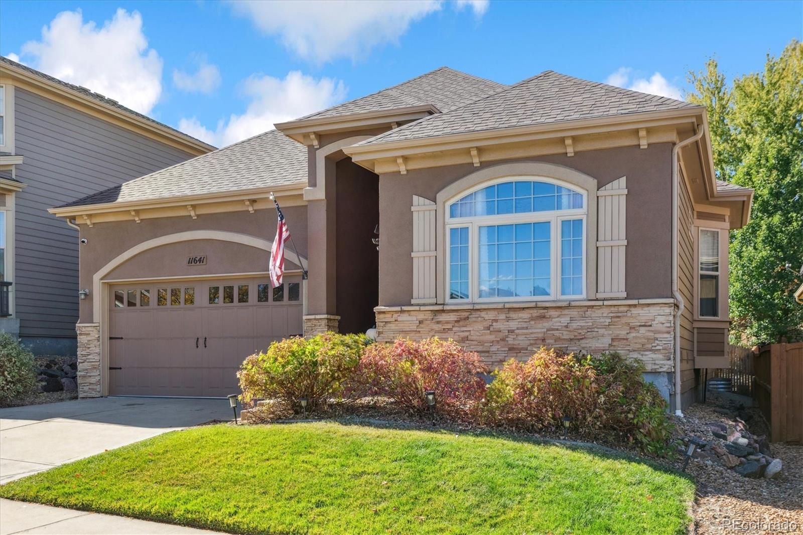 11641 Colony Loop Parker, CO 80138 - Photo 2 of 37 a front view of a house with garden