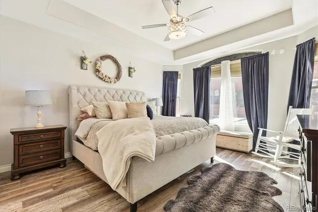 a bedroom with a bed and a chandelier