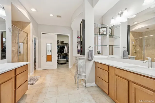 a spacious bathroom with a granite countertop sink mirror and shower