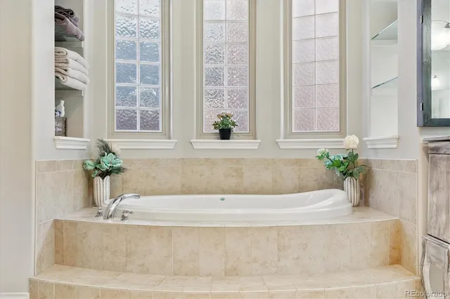 a white bath tub sitting in front of a window