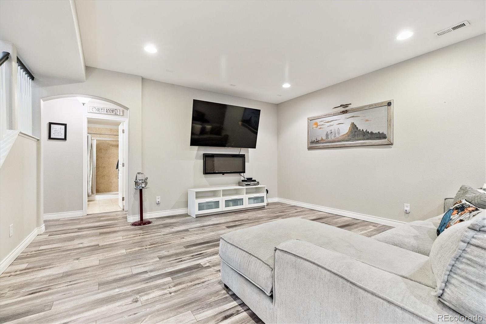 11641 Colony Loop Parker, CO 80138 - Photo 25 of 37 a living room with furniture and a flat screen tv