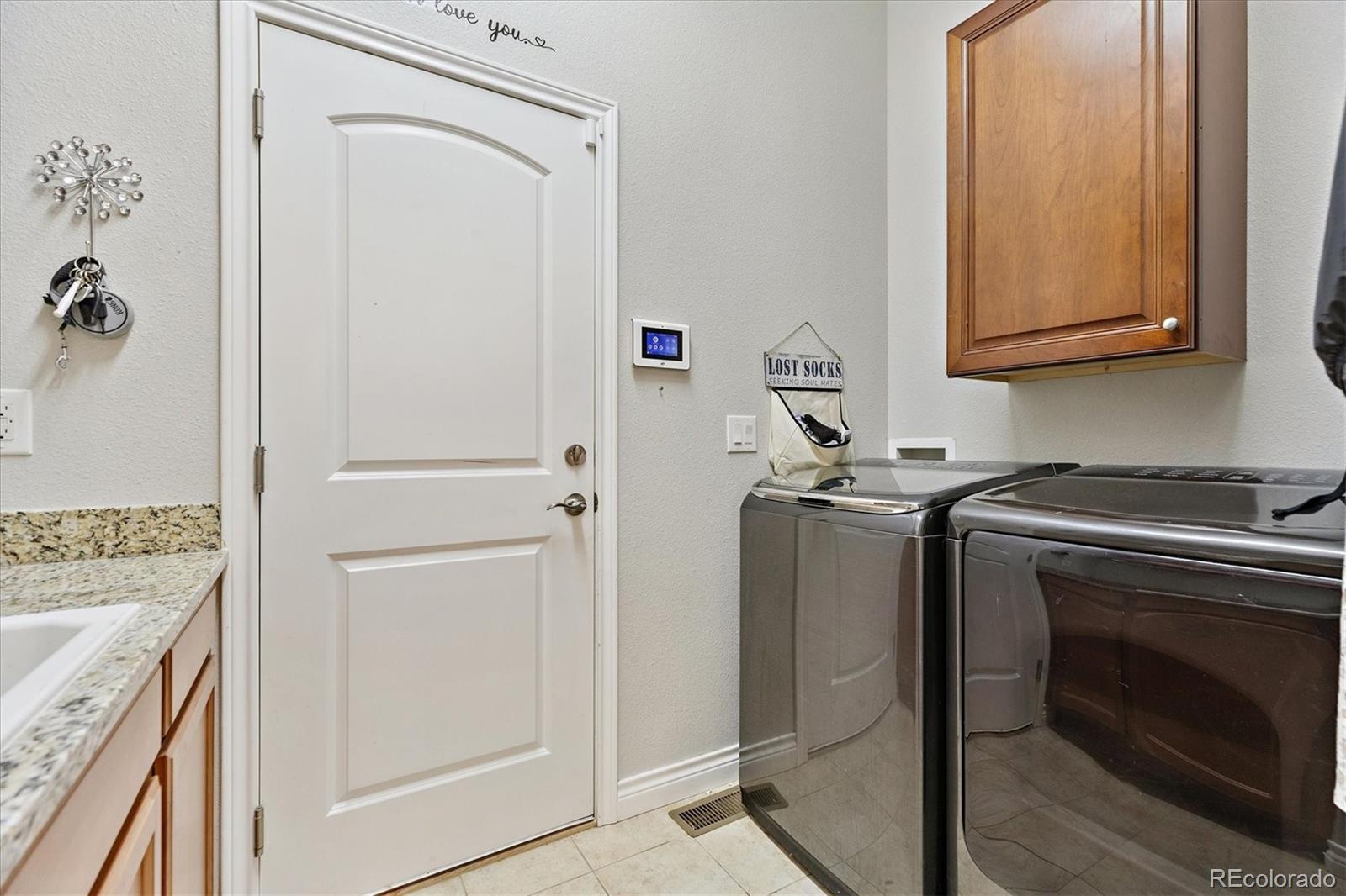 11641 Colony Loop Parker, CO 80138 - Photo 29 of 37 a kitchen with a refrigerator and cabinets