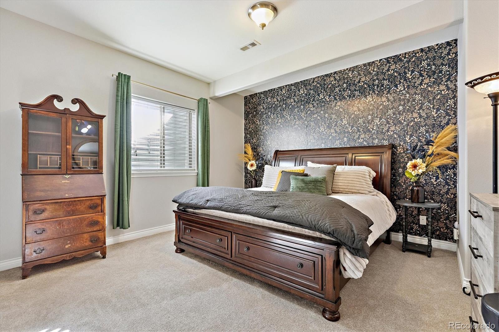 11641 Colony Loop Parker, CO 80138 - Photo 32 of 37 a bedroom with a bed and a cabinets