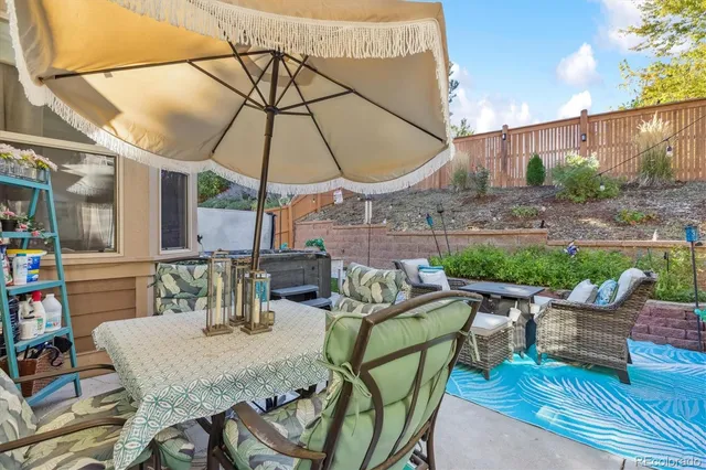 a patio with a table and chairs