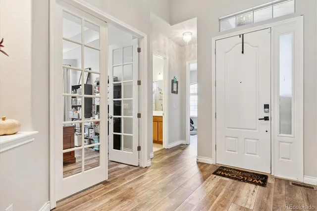 a view of empty room with wooden floor and cabinet
