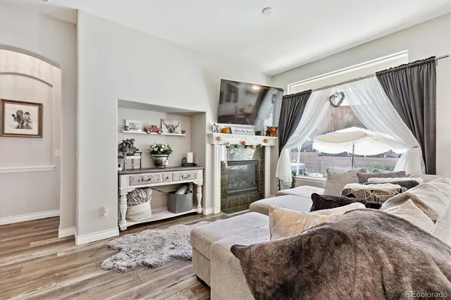 a bedroom with a bed a large window and a flat tv screen