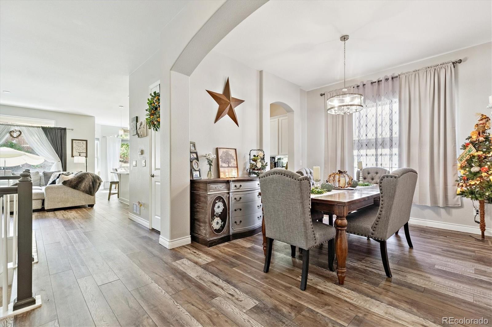 11641 Colony Loop Parker, CO 80138 - Photo 10 of 37 a view of a dining room with furniture window and wooden floor
