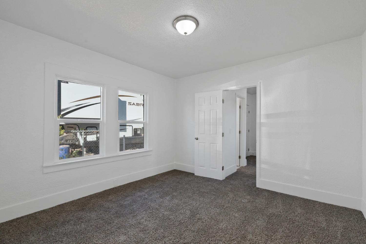 3321 East Montecito Avenue Fresno, CA 93702 - Photo 15 of 22 an empty room with windows and closet